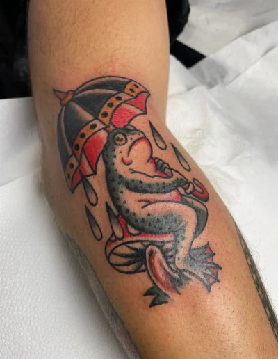 rana triste con un paraguas